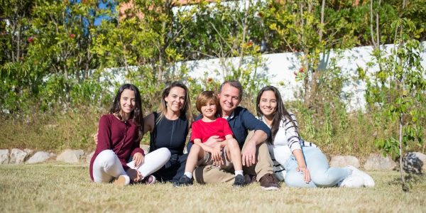 A joyful family enjoying sunny moments in a lush Portuguese garden.